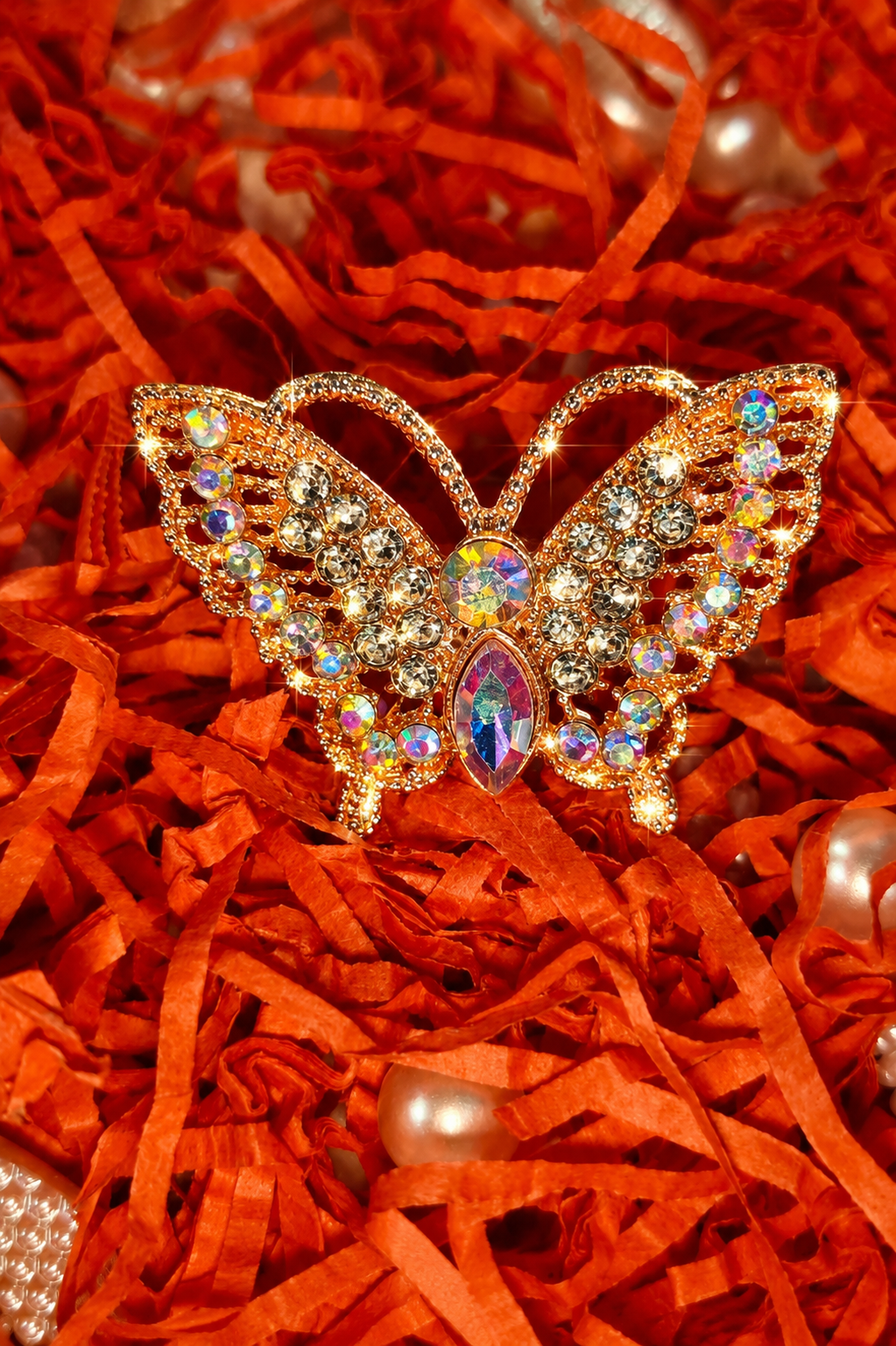Gold-tone butterfly crystal ring with purple-blue marquise center and rainbow accents