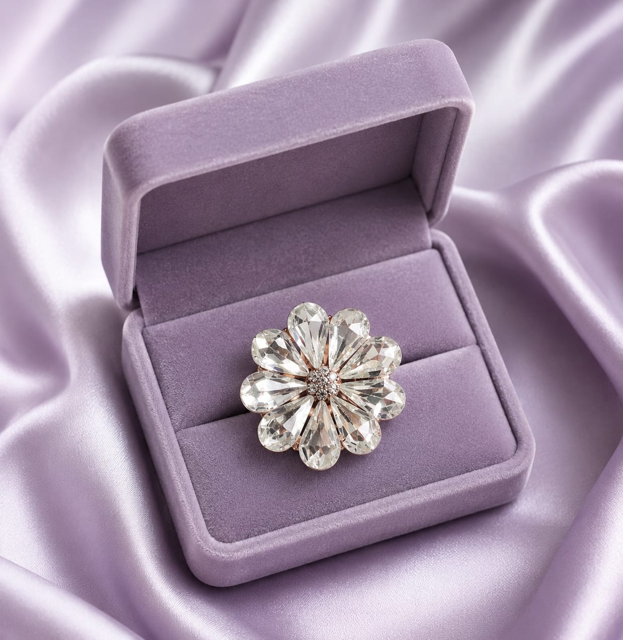 Statement ring with crystal flower centerpiece and round clear stones, displayed in box