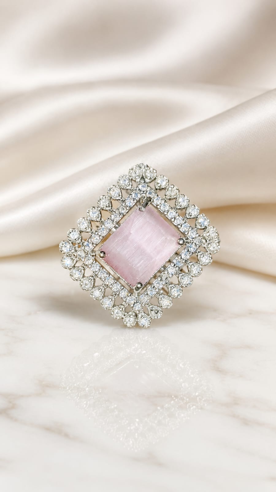 Silver halo statement ring with square blush pink center stone and clear sparkle border