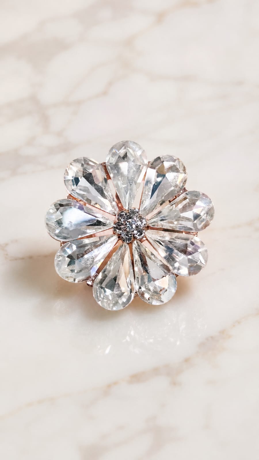 Crystal flower statement ring with central dark detail and clear round stones