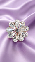 Crystal flower statement ring with clear round stones and centered dark detail