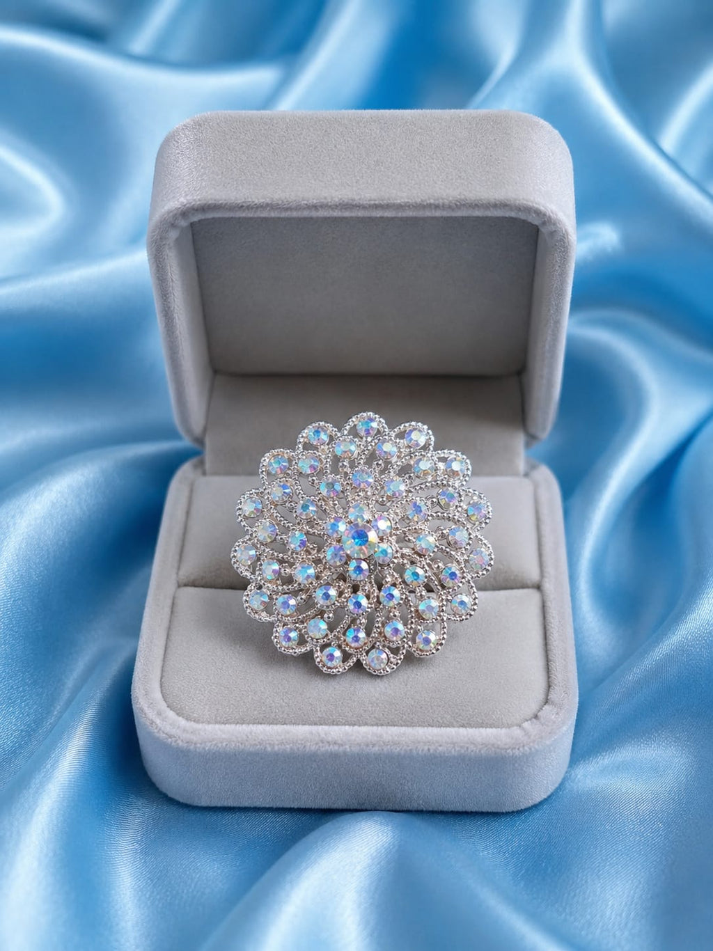 Rose gold-plated statement ring with blue and clear round rhinestone cluster in box