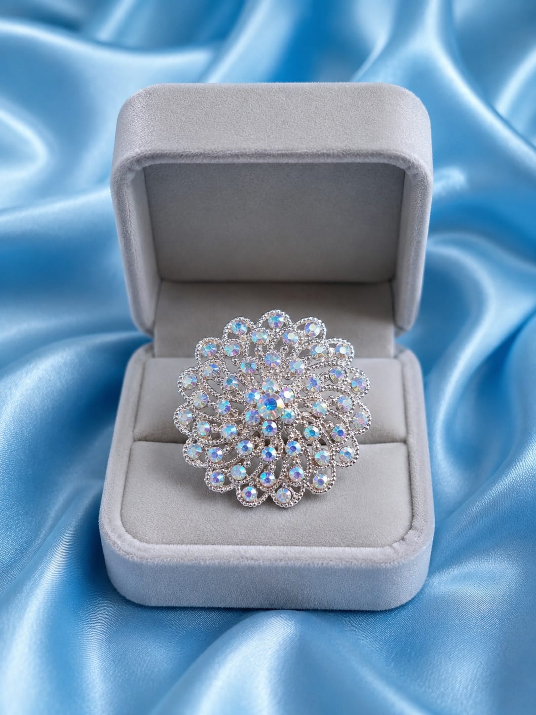 Rose gold-plated statement ring with blue and clear round rhinestone cluster in box