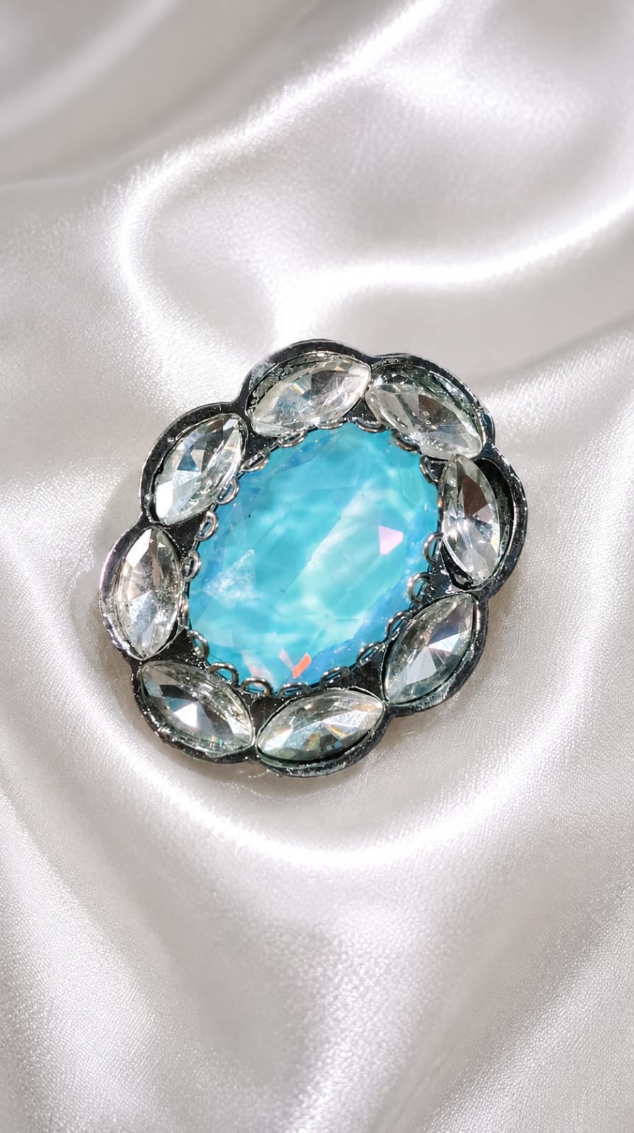 Gunmetal halo statement ring with oval aqua-blue gemstone and faceted oval side crystals
