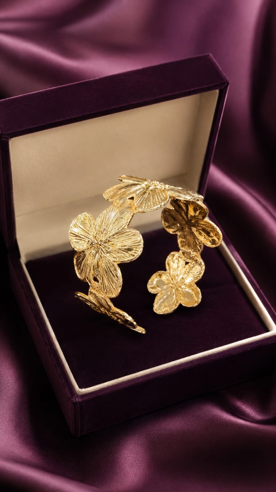 Gold-plated floral cuff bracelet with raised flower and leaf details