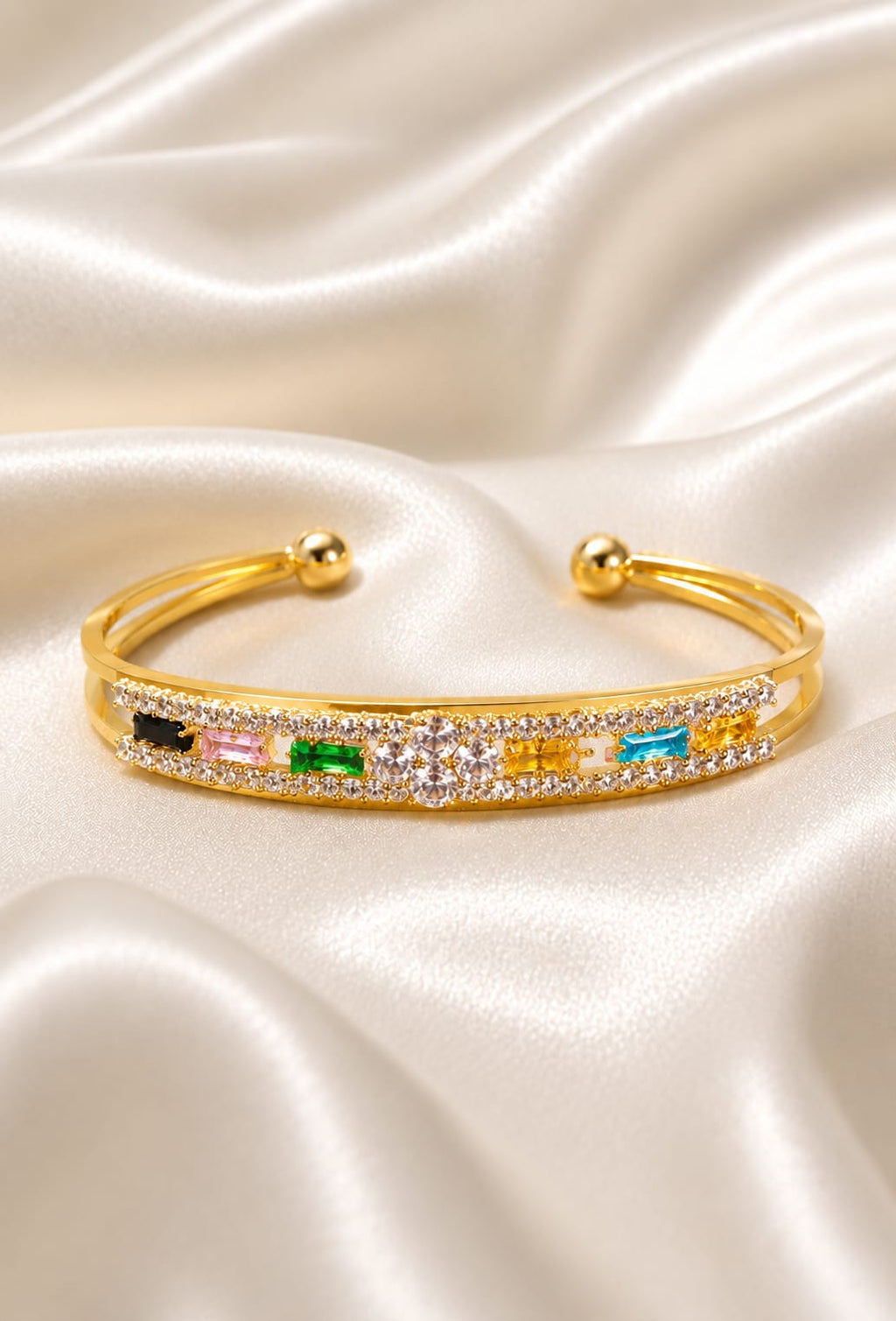 Gold-plated crystal cuff bracelet with multicolor stones, hinged ball end clasps