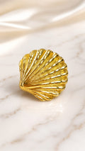 Gold seashell statement ring with ridged shell texture close-up