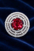 Statement ring with round ruby-red center stone and pavé halo