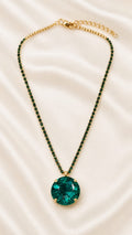 Gold-plated crystal pendant necklace with emerald green oval gemstone