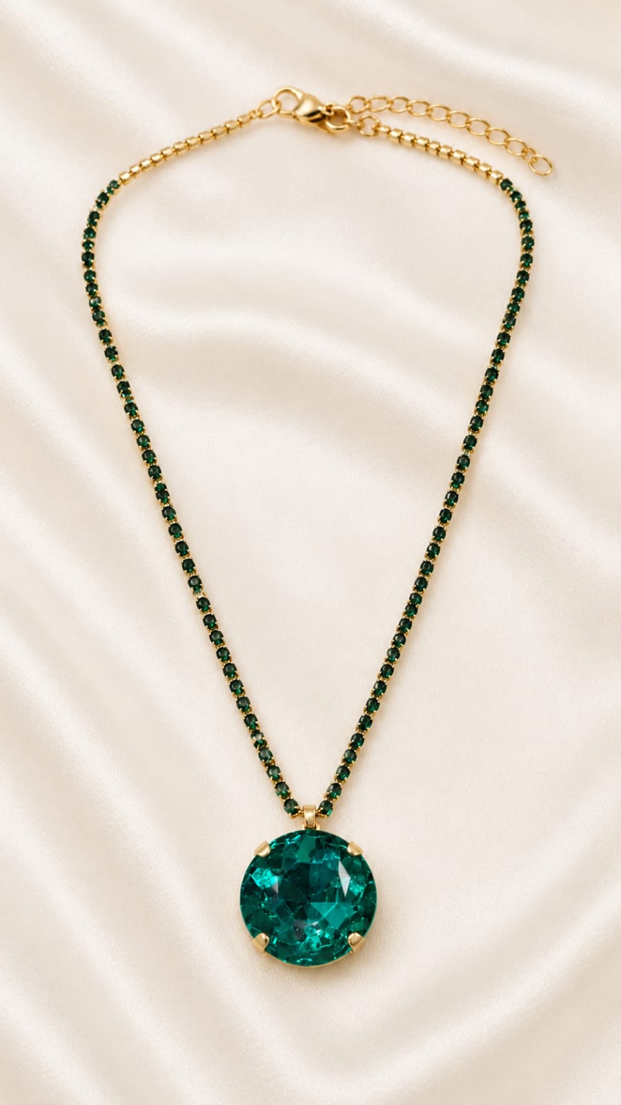 Gold-plated crystal pendant necklace with emerald green oval gemstone
