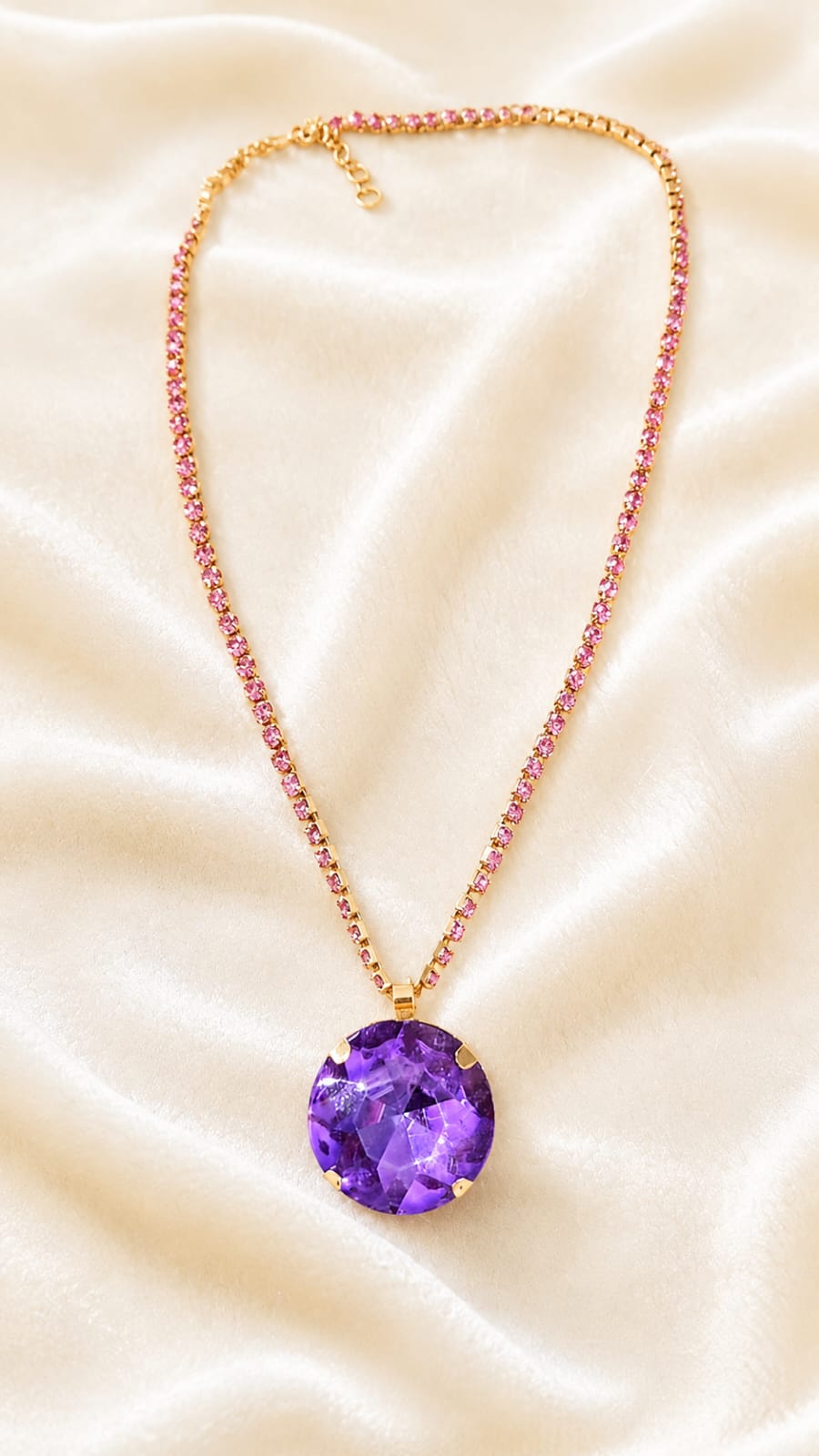 Gold-plated pendant necklace with red jeweled chain and round purple crystal charm