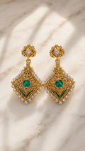 Gold-tone filigree drop earrings with emerald green center stones and clear crystal accents