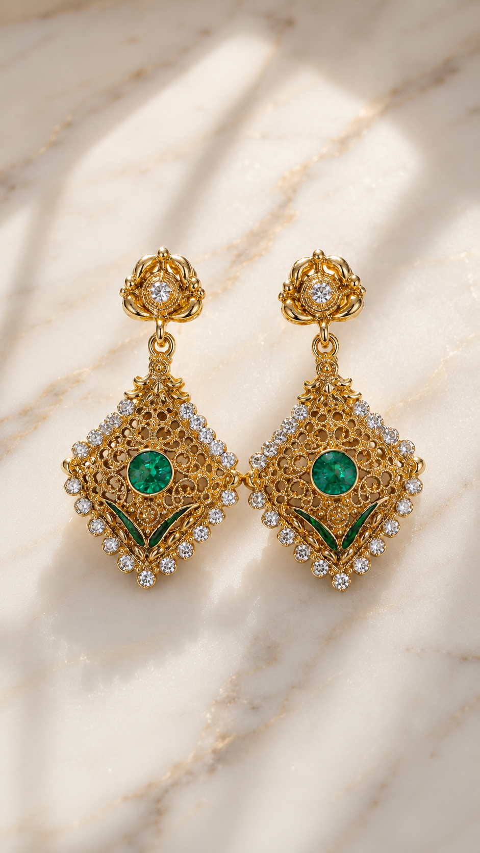 Gold-tone filigree drop earrings with emerald green center stones and clear crystal accents