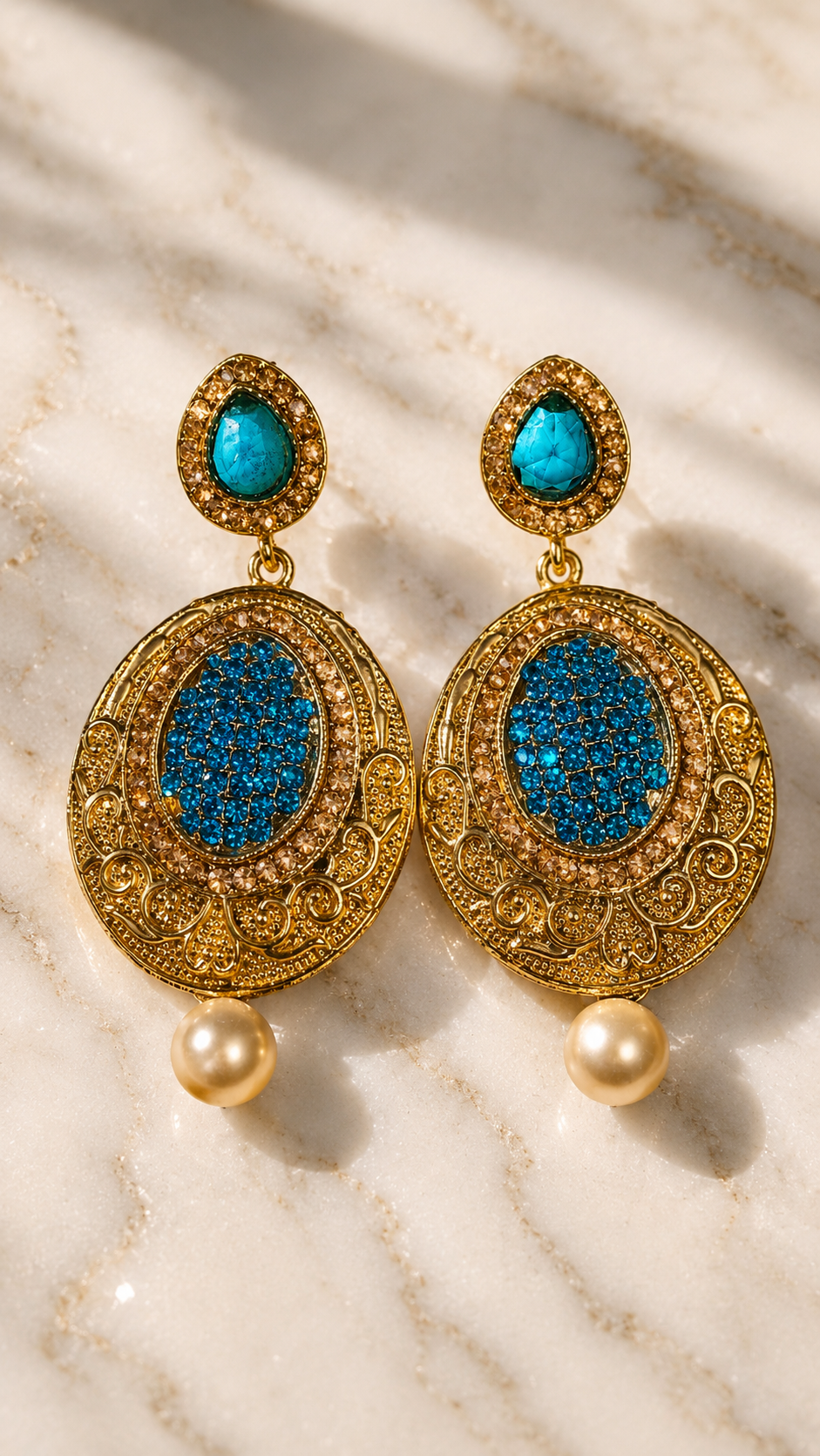 Gold-tone turquoise drop earrings with oval filigree, blue center, and pearl dangles