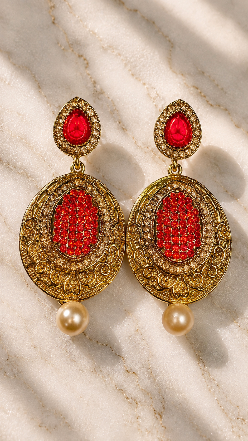 Gold-tone red oval filigree drop earrings with red stone centers and dangling pearls