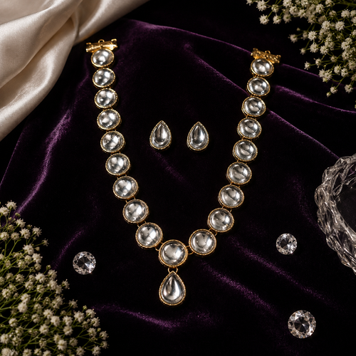 Gold-tone statement jewelry set with pearl-like beads, teardrop charms, and matching earrings