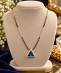 Triangle pendant mangalsutra necklace with blue triangle stone, gold-tone chain, black beads