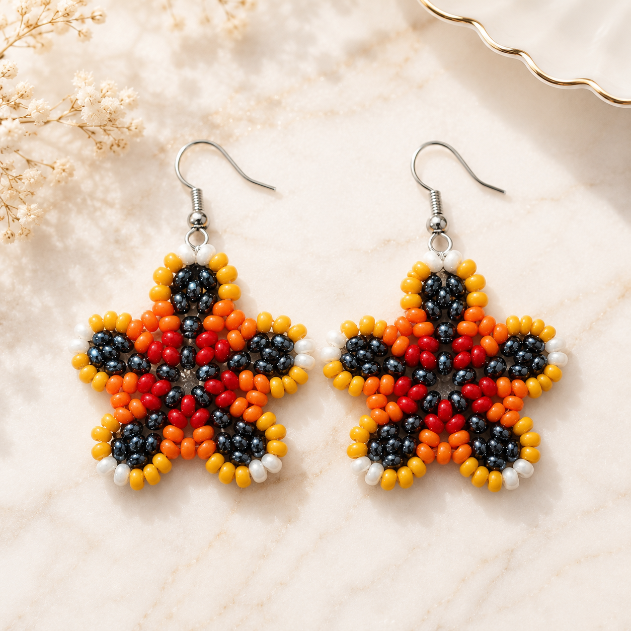Beaded floral dangle earrings with orange, red, and black beads, silver hooks