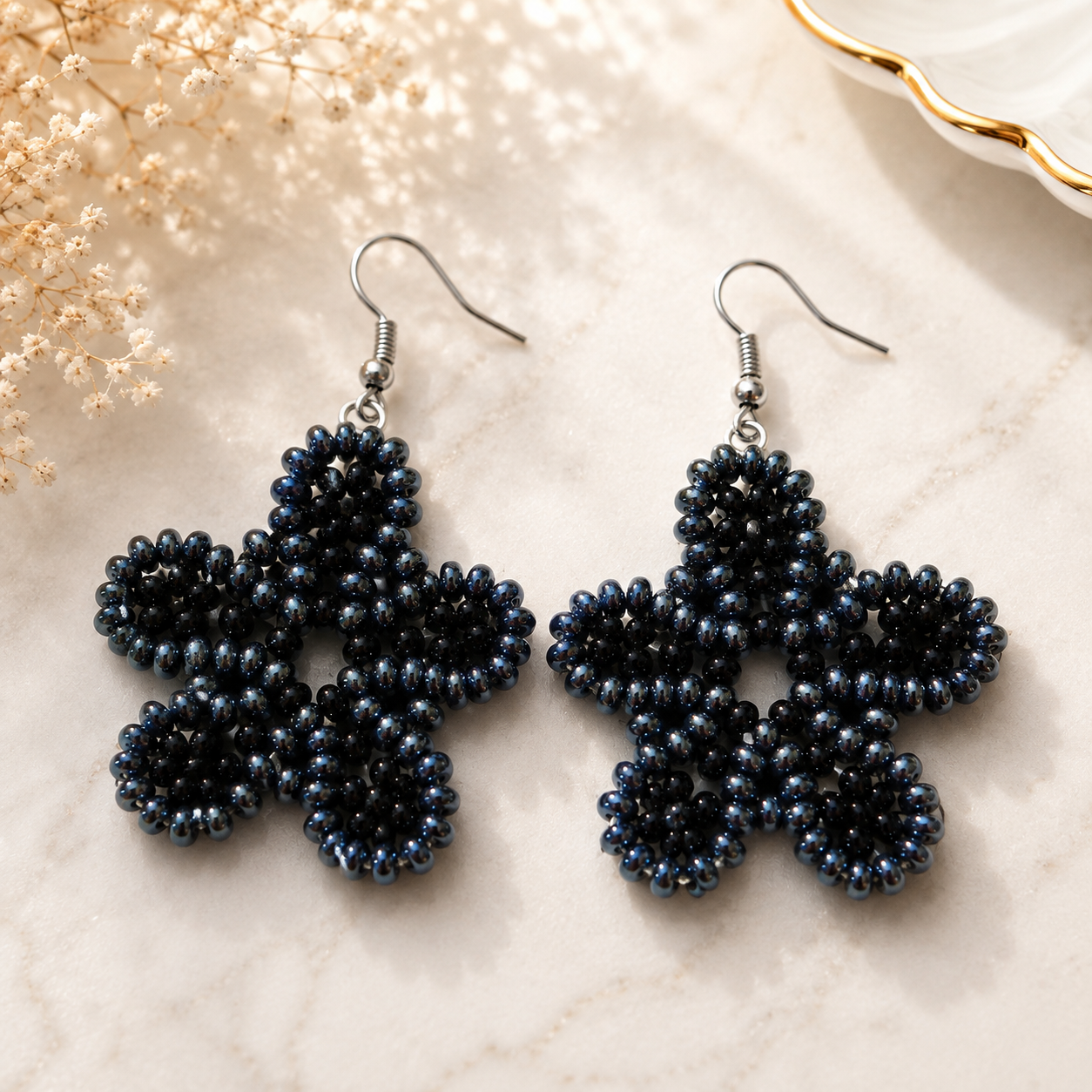 Midnight blue and black beaded floral earrings with dangling hook backs