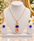 Gold-tone multicolor geometric pendant necklace set with blue stud earrings on display