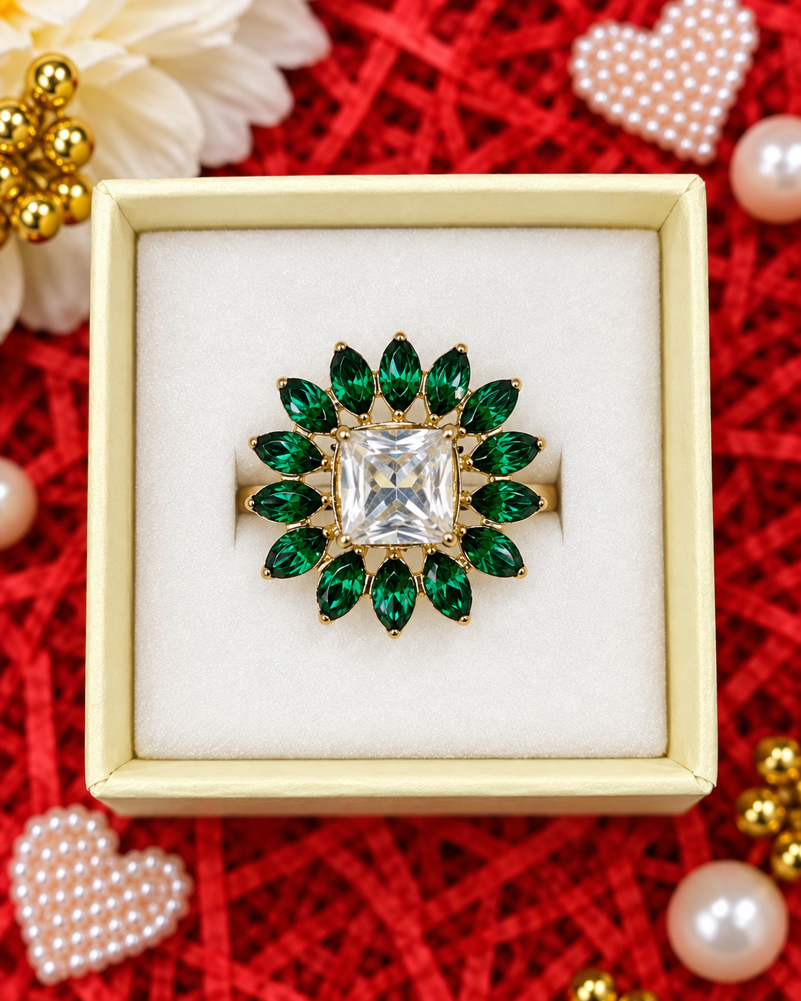Gold statement ring with square crystal center and emerald-green floral stones