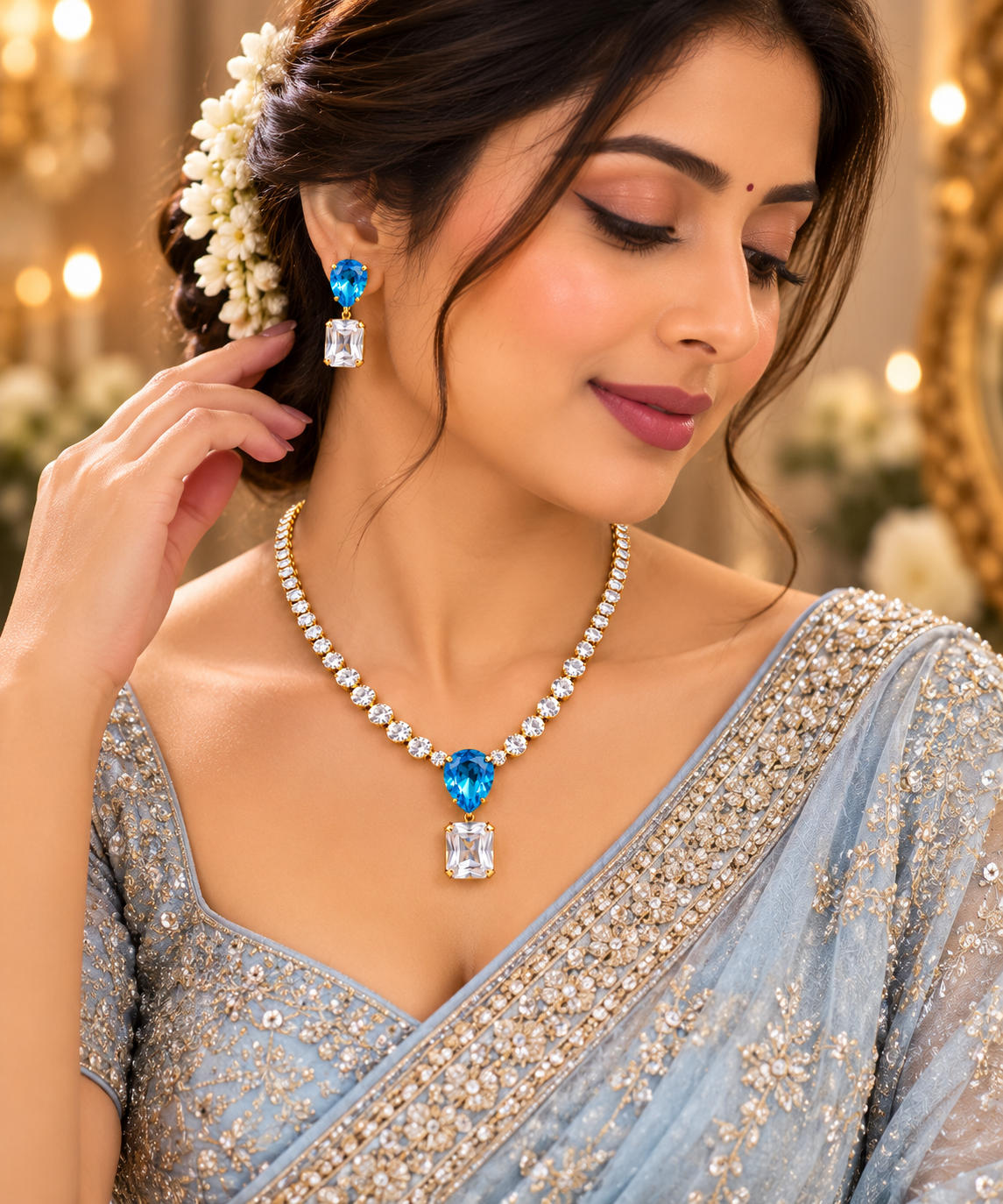 Blue teardrop pendant necklace with matching earrings on model