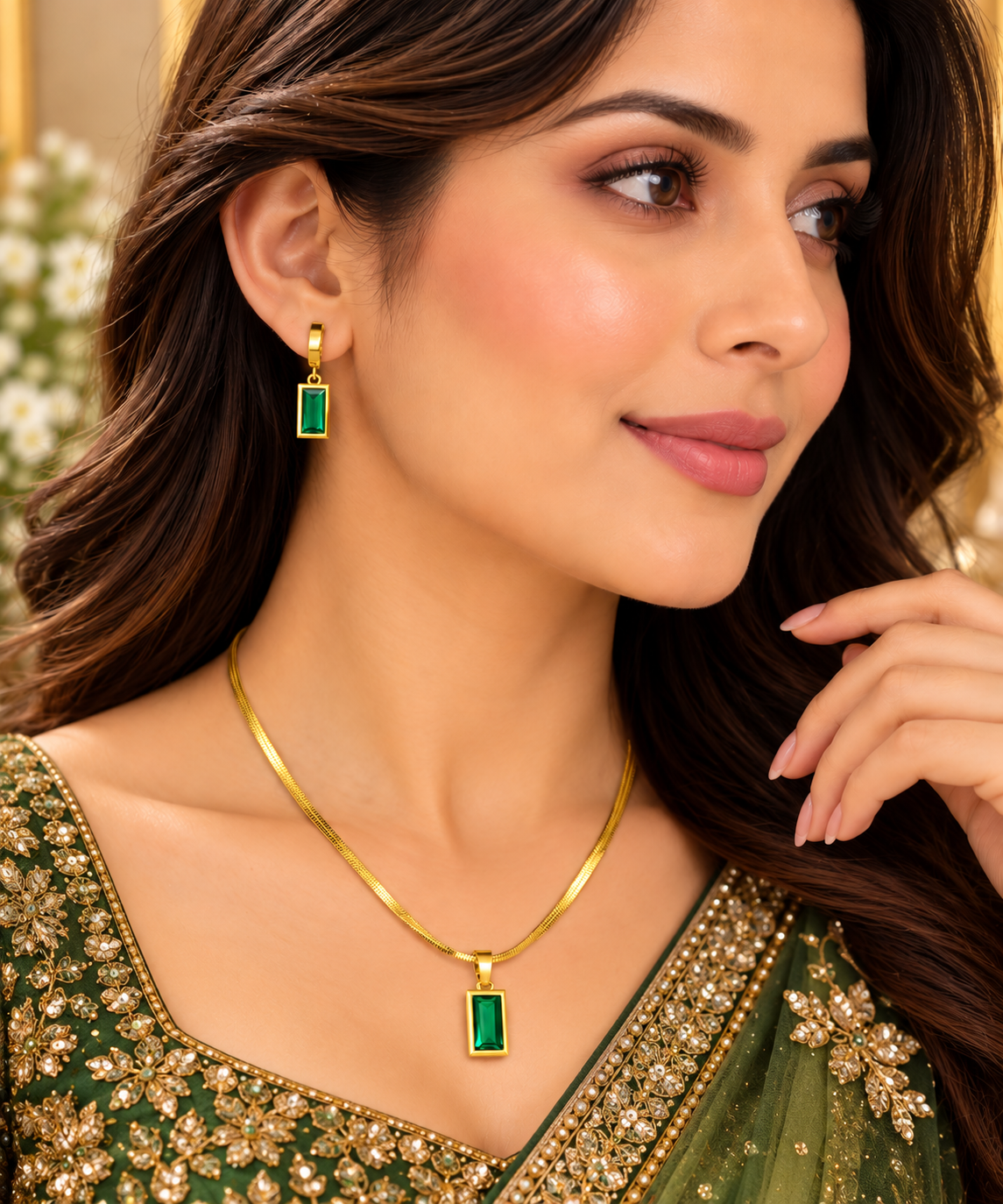 Gold-tone necklace with rectangular emerald green pendant and matching earrings on model