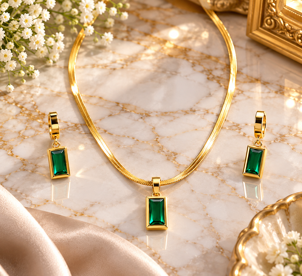 Gold-tone rope chain necklace with rectangular emerald green pendant and matching earrings