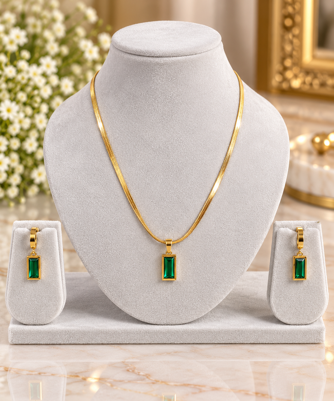 Gold-tone necklace set with rectangular emerald green pendants and matching stud earrings