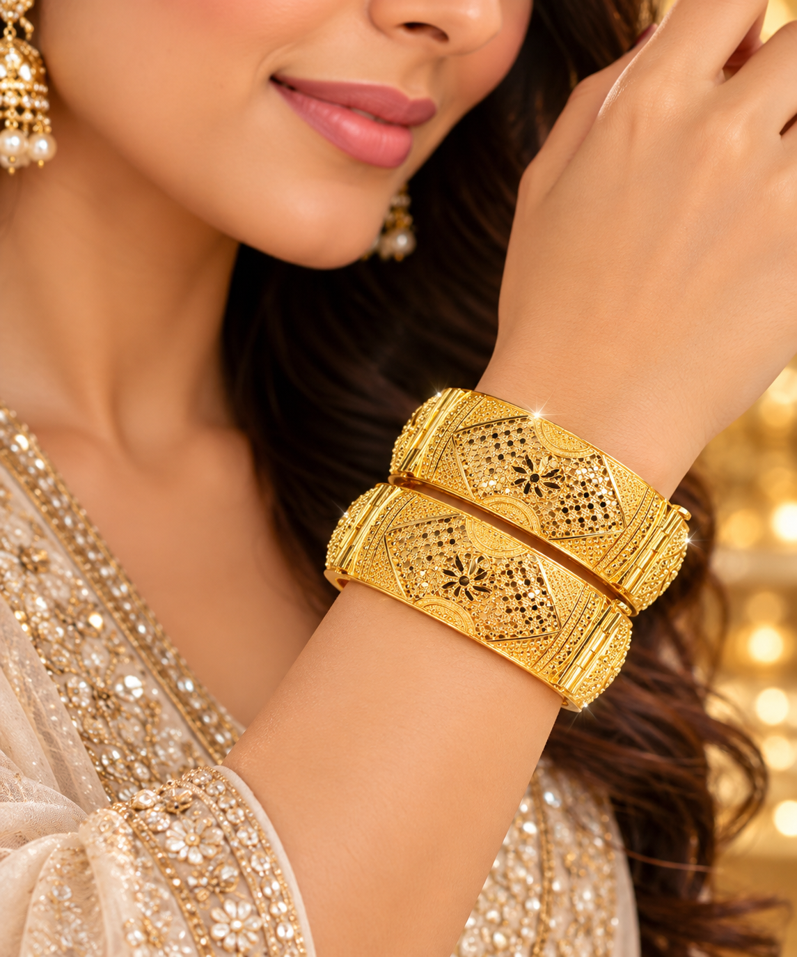 Gold-tone filigree kada set: two wide bangles on wrist