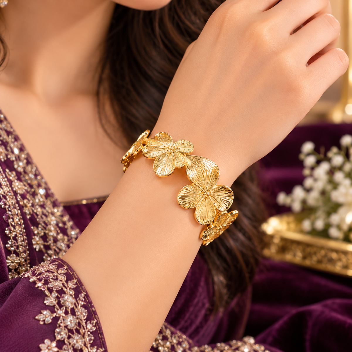 Gold-plated floral cuff bracelet with three raised flower medallions
