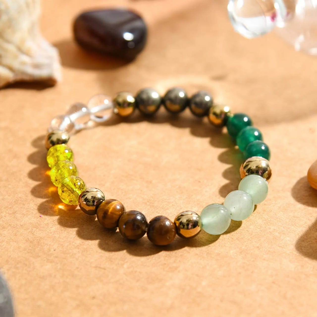 Crystal bracelet with green, tiger-eye and pale light-blue beads plus gold-tone balls
