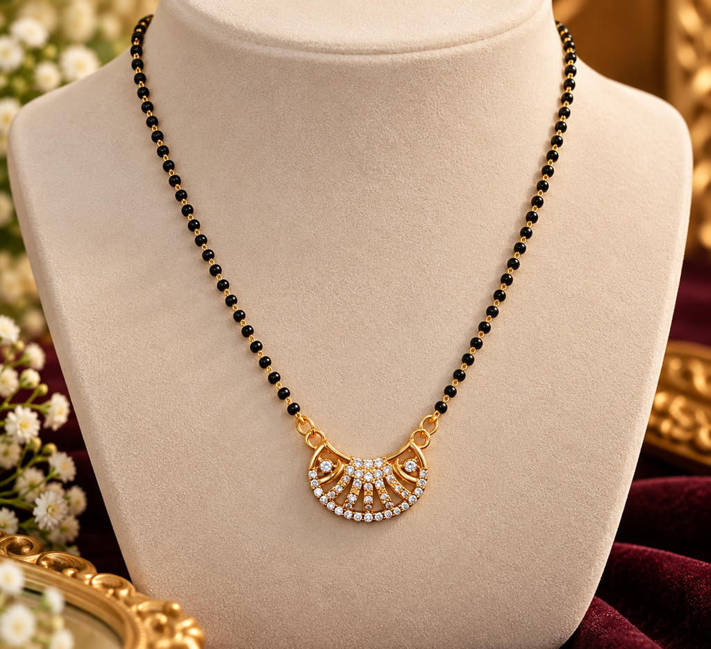 Gold-tone mangalsutra necklace with black bead chain and fan-shaped crystal pendant