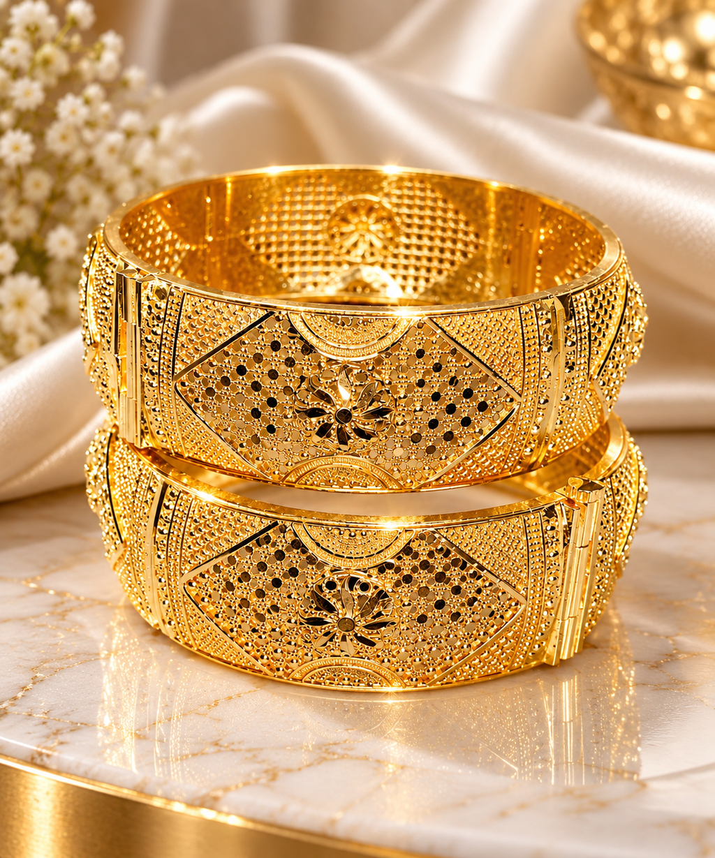 Gold-tone filigree kada set with intricate center motifs, two stacked bangles