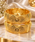 Gold-tone filigree kada set with intricate center motifs, two stacked bangles
