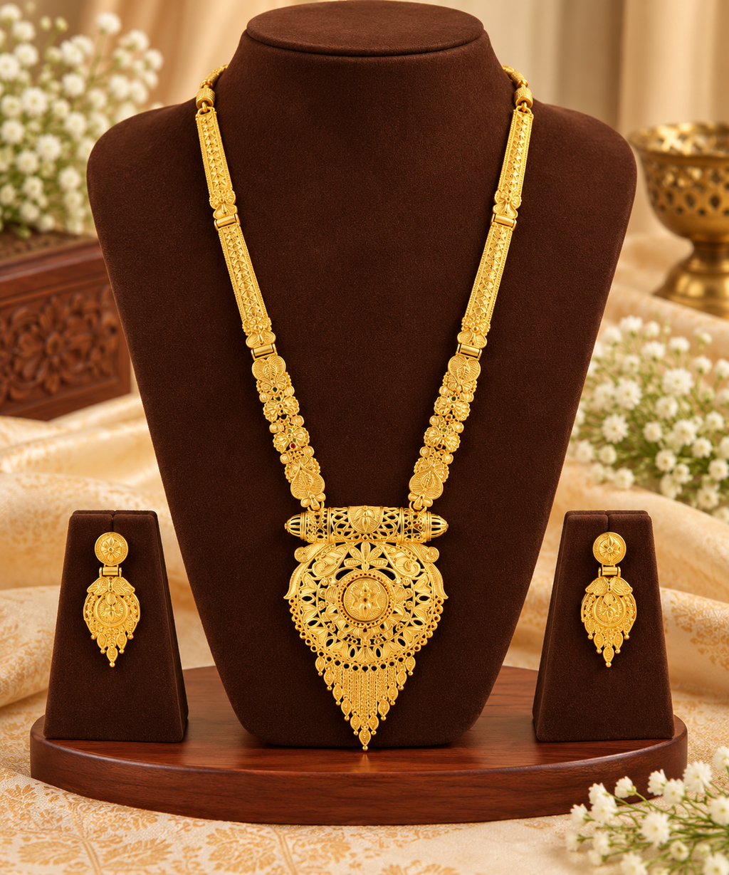 Gold-tone filigree necklace with matching dangling earrings, triangular central pendant.