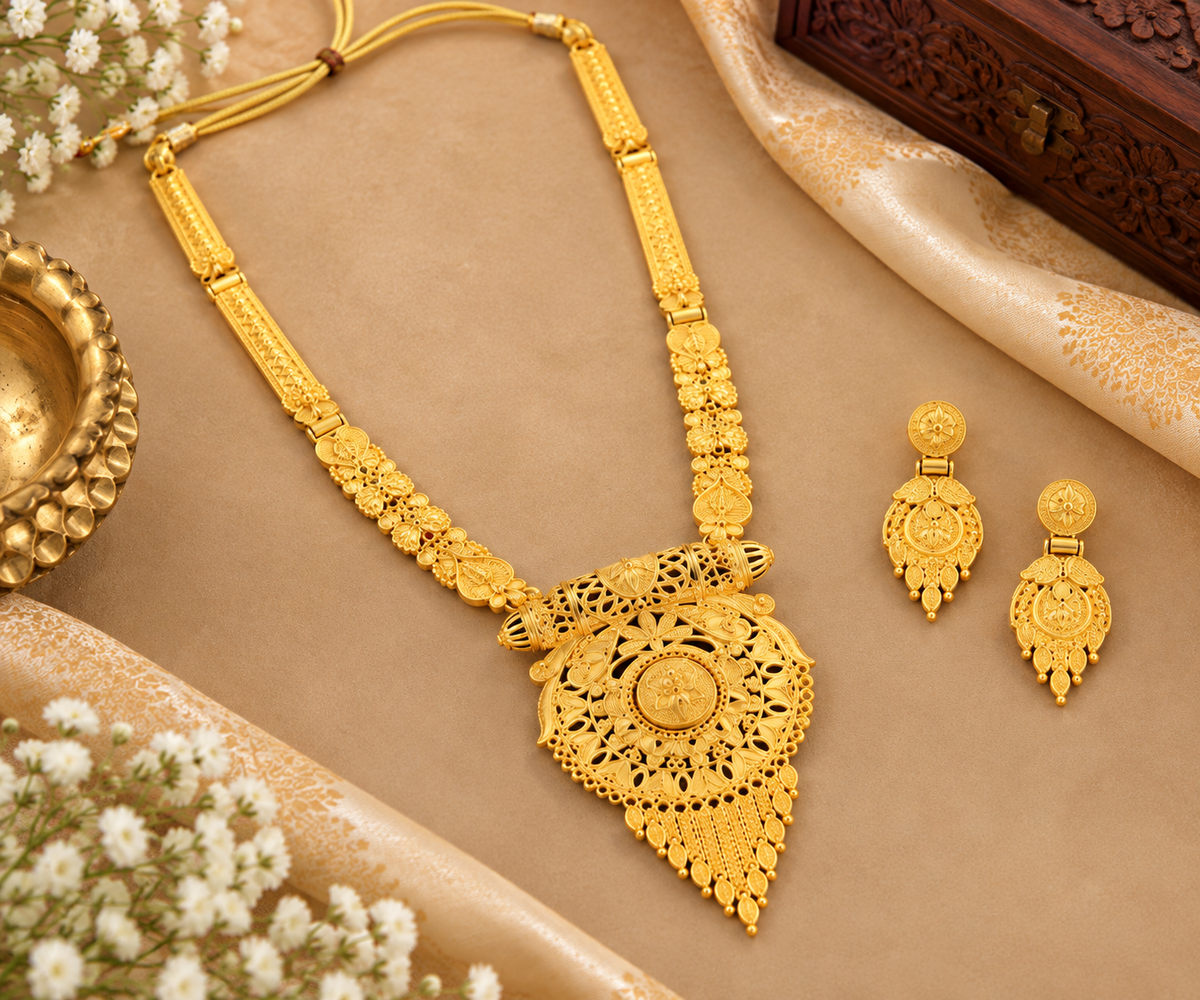Gold-tone filigree necklace set with triangular pendant and two matching drop earrings.