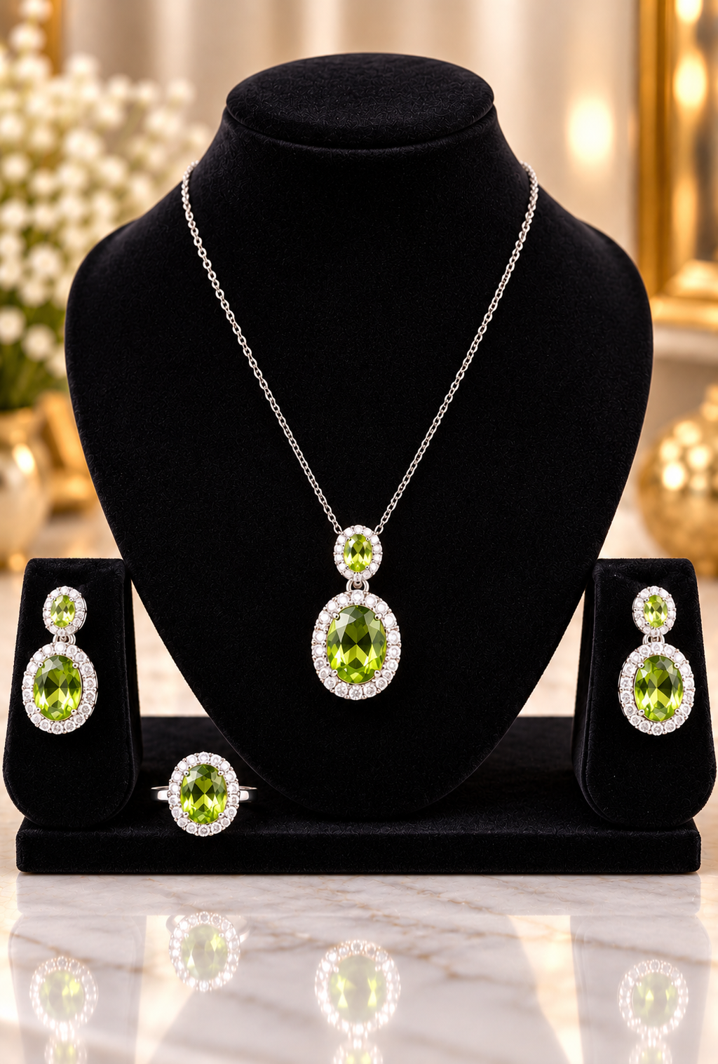 Silver necklace set with oval green center stone, matching earrings on dark display