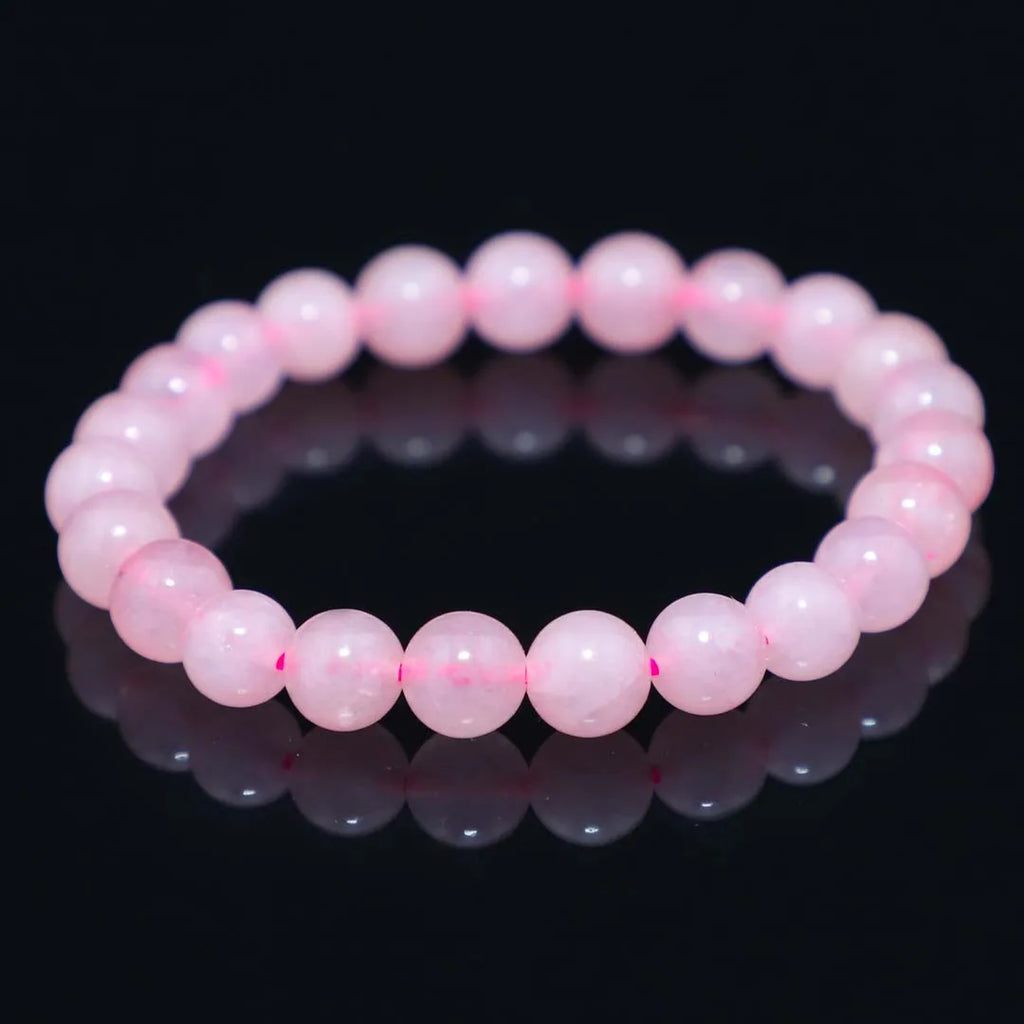 Rose quartz crystal bracelet with smooth round beads, stretchy cord