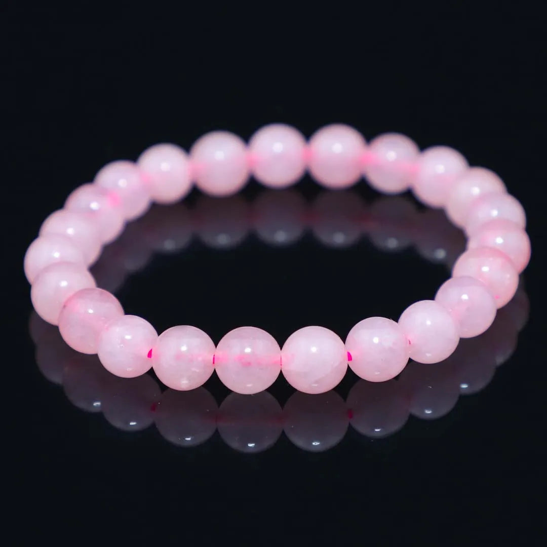 Rose quartz crystal bracelet with smooth round beads, stretchy cord