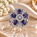 Purple crystal statement ring with round center stone and halo of clear gems