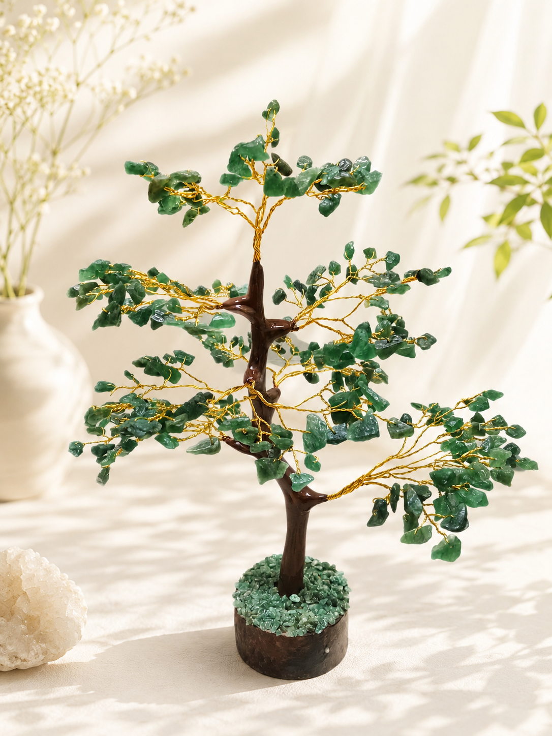 Green aventurine crystal tree with green crystal branches, gold-toned trunk, and stone base