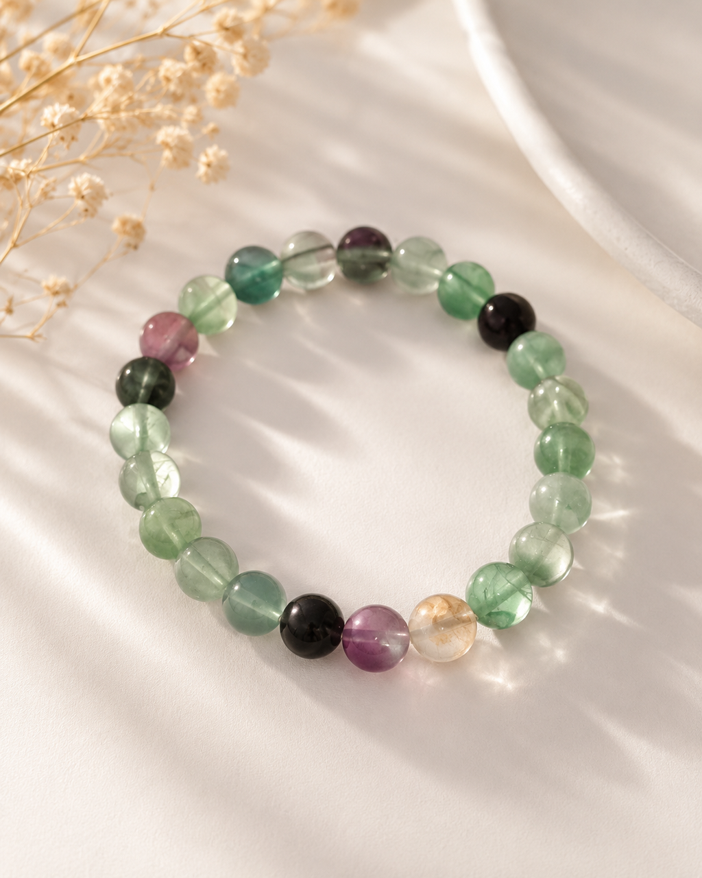 Beaded bracelet with green, smoky dark and clear crystal beads, round polished stones